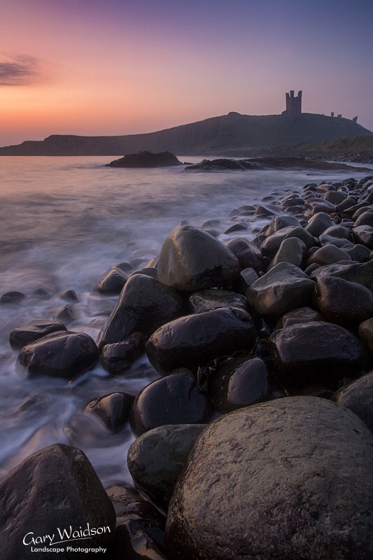 Dunstanburgh castle at dawn. Landscape photography by Gary Waidson.